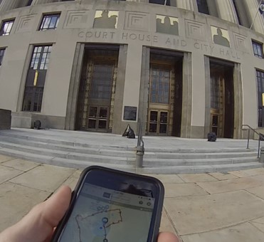 Photograph of participant approaching the downtown Nashville court house holding smartphone